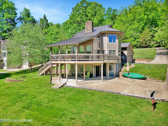 763 Lochober Rd, Leitchfield, KY 42754 - rear view of house with a standing seam roof, a patio area, a wooden deck, a yard, and metal roof