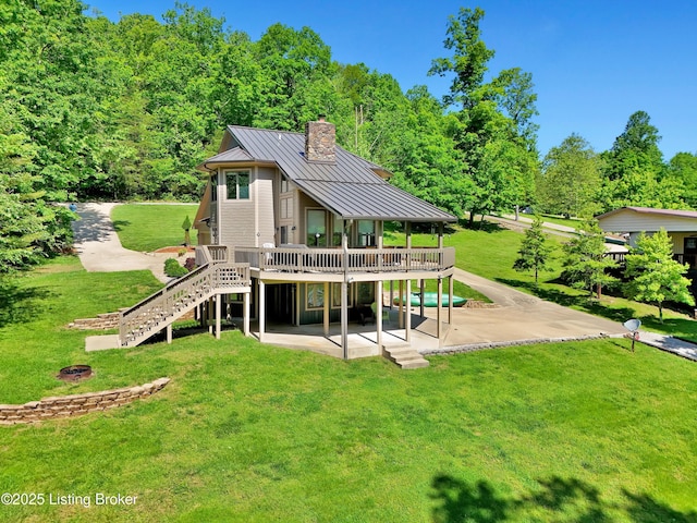 763 Lochober Rd, Leitchfield, KY 42754 - back of property with a standing seam roof, a patio area, a deck, stairway, and a chimney