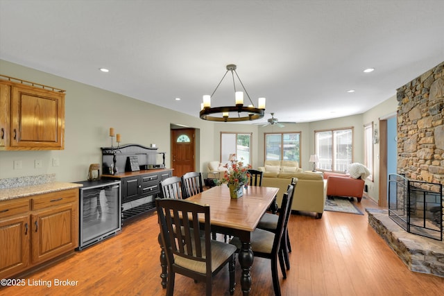 763 Lochober Rd, Leitchfield, KY 42754 - dining area featuring beverage cooler, recessed lighting, a chandelier, light wood finished floors, and a fireplace