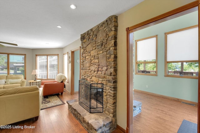 763 Lochober Rd, Leitchfield, KY 42754 - living room featuring a stone fireplace, healthy amount of natural light, wood finished floors, baseboards, and recessed lighting
