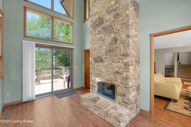 763 Lochober Rd, Leitchfield, KY 42754 - unfurnished living room with a high ceiling, wood finished floors, stairs, and a fireplace