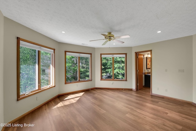 763 Lochober Rd, Leitchfield, KY 42754 - empty room featuring light wood-style floors, plenty of natural light, a textured ceiling, ceiling fan, and recessed lighting