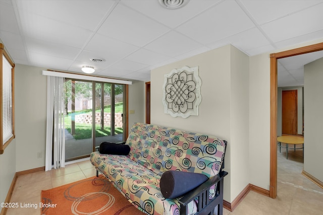 763 Lochober Rd, Leitchfield, KY 42754 - living room featuring a drop ceiling, light tile patterned floors, and baseboards