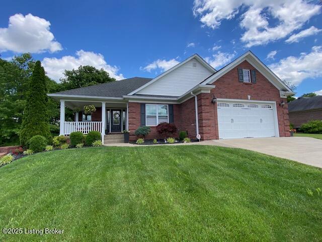117 N Howard St, Bardstown, KY 40004 - view of front of property with driveway, covered porch, brick siding, a front lawn, and an attached garage