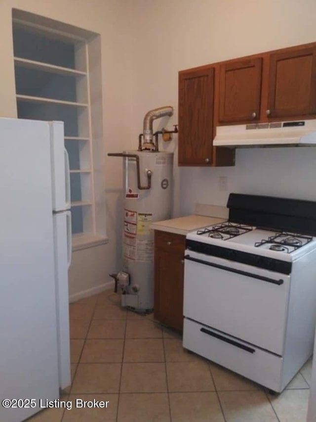 224 E Oak St, Louisville, KY 40203 - kitchen with white appliances, water heater, under cabinet range hood, and light tile patterned floors