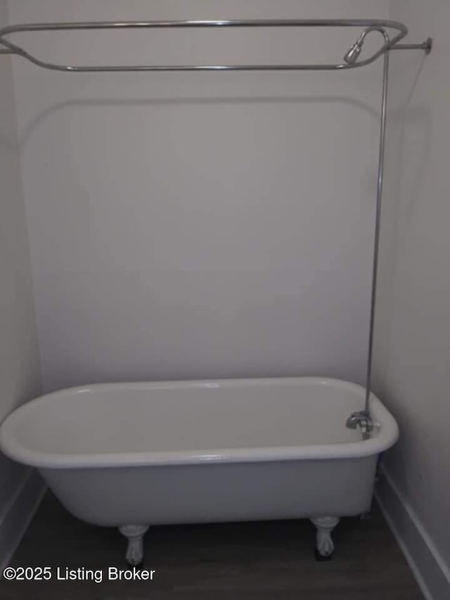 224 E Oak St, Louisville, KY 40203 - full bath featuring a soaking tub, baseboards, and wood finished floors