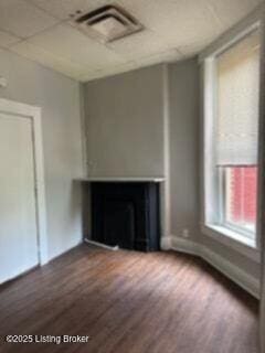 224 E Oak St, Louisville, KY 40203 - unfurnished living room featuring a fireplace, wood finished floors, baseboards, and a paneled ceiling