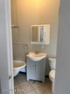 224 E Oak St, Louisville, KY 40203 - bathroom featuring toilet, vanity, and tile patterned flooring