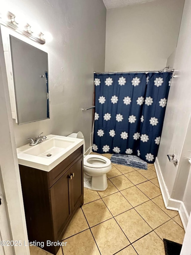 224 E Oak St, Louisville, KY 40203 - bathroom featuring toilet, vanity, tile patterned flooring, baseboards, and a shower with curtain