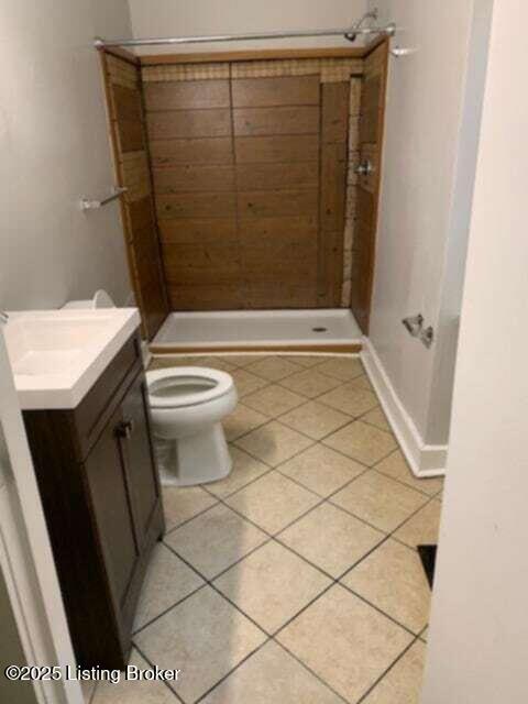 224 E Oak St, Louisville, KY 40203 - full bath with vanity, tile patterned flooring, toilet, and a shower