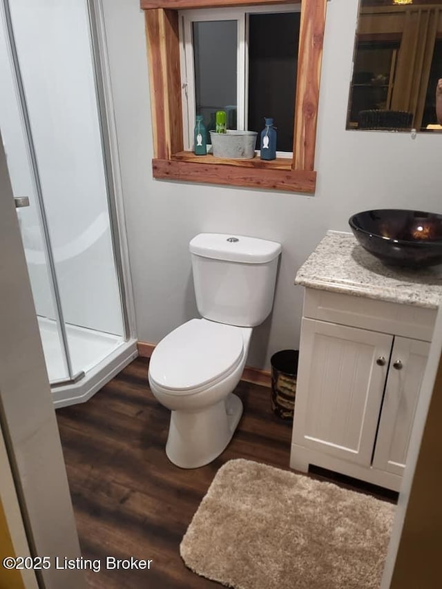 41 Hidden Valley Ln Unit B, Hudson, KY 40145 - bathroom with vanity, wood finished floors, a stall shower, toilet, and baseboards