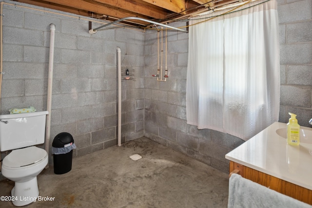 3297 E Gap Hill Rd, Cub Run, KY 42729 - full bathroom featuring toilet, concrete floors, vanity, tiled shower, and concrete block wall