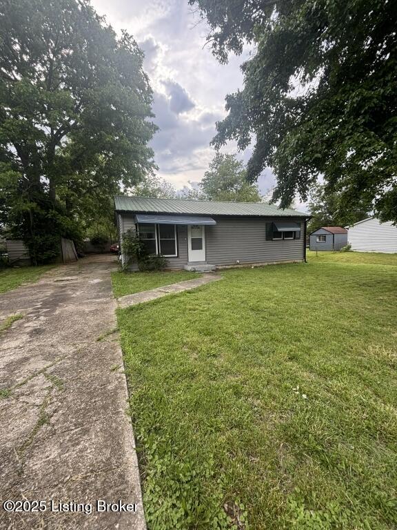 9304 New Maple Rd, Louisville, KY 40229 - view of front facade featuring concrete driveway and a front yard