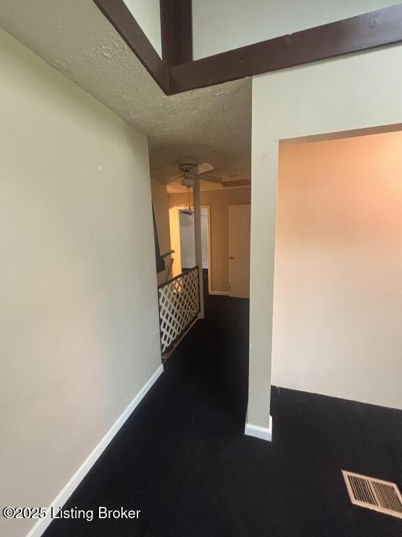 9304 New Maple Rd, Louisville, KY 40229 - corridor featuring baseboards and a textured ceiling