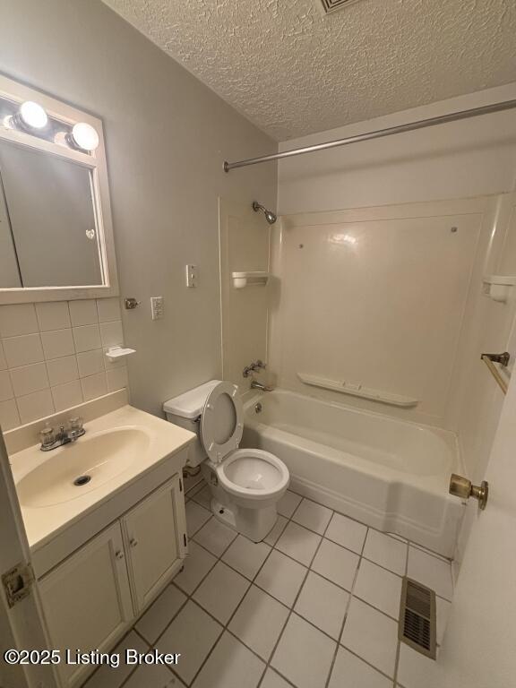 9304 New Maple Rd, Louisville, KY 40229 - bathroom with tile patterned floors, vanity, tub / shower combination, a textured ceiling, and backsplash