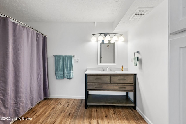 9605 Cooks Mill Rd, Georgetown, IN 47122 - bathroom with vanity, baseboards, wood finished floors, a textured ceiling, and curtained shower