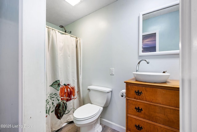 9605 Cooks Mill Rd, Georgetown, IN 47122 - bathroom with vanity, toilet, wood finished floors, baseboards, and a shower with curtain