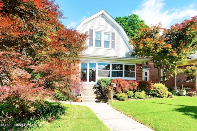 4714 Burkley Ave, Louisville, KY 40214 - dutch colonial featuring a gambrel roof, a front yard, entry steps, and brick siding