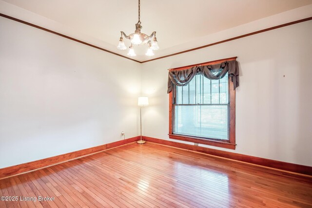 4714 Burkley Ave, Louisville, KY 40214 - unfurnished room with a chandelier, baseboards, hardwood / wood-style floors, and ornamental molding