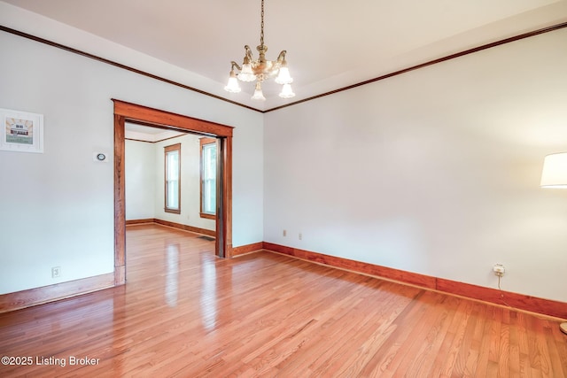 4714 Burkley Ave, Louisville, KY 40214 - spare room with a chandelier, baseboards, light wood-type flooring, and crown molding