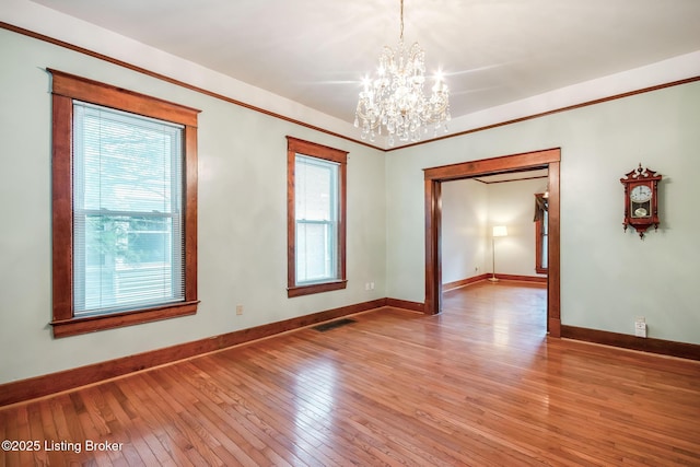 4714 Burkley Ave, Louisville, KY 40214 - unfurnished room featuring a chandelier, plenty of natural light, light wood-style flooring, and baseboards