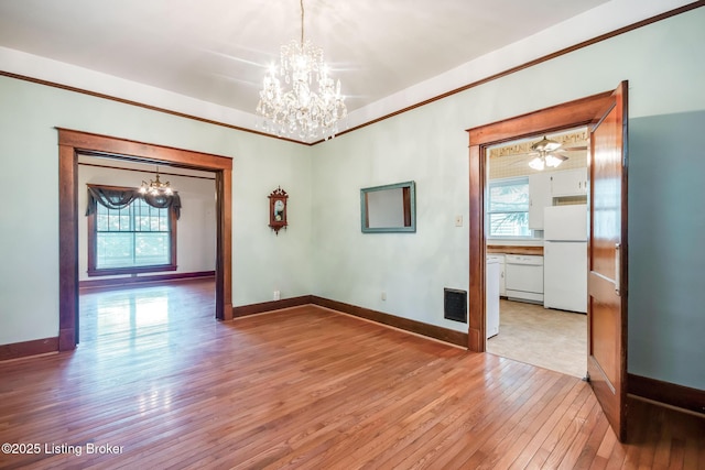 4714 Burkley Ave, Louisville, KY 40214 - unfurnished room featuring a chandelier, plenty of natural light, light wood-type flooring, baseboards, and ornamental molding