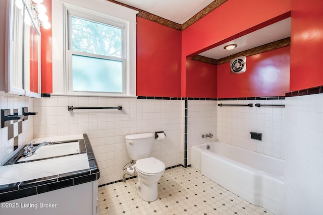 4714 Burkley Ave, Louisville, KY 40214 - bathroom featuring toilet, vanity, tile walls, a garden tub, and wainscoting