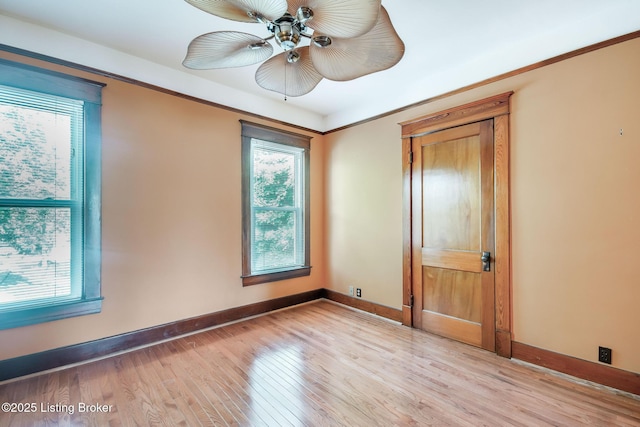 4714 Burkley Ave, Louisville, KY 40214 - unfurnished room featuring plenty of natural light, light wood-style floors, baseboards, and a ceiling fan