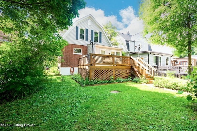 4714 Burkley Ave, Louisville, KY 40214 - back of property with a gambrel roof, a deck, and a lawn