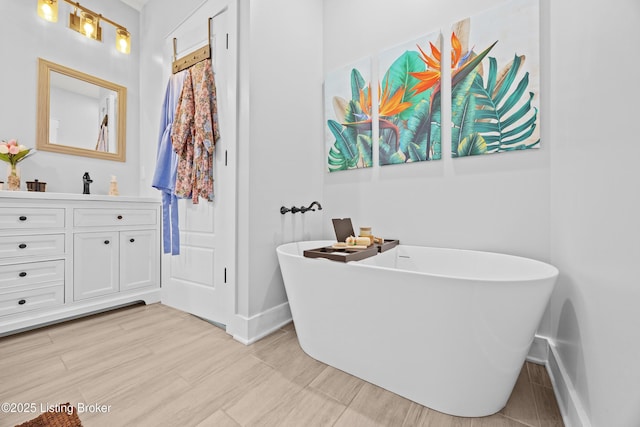 37 Lazy J Ln, Brandenburg, KY 40108 - bathroom featuring baseboards, vanity, a freestanding bath, and wood finished floors