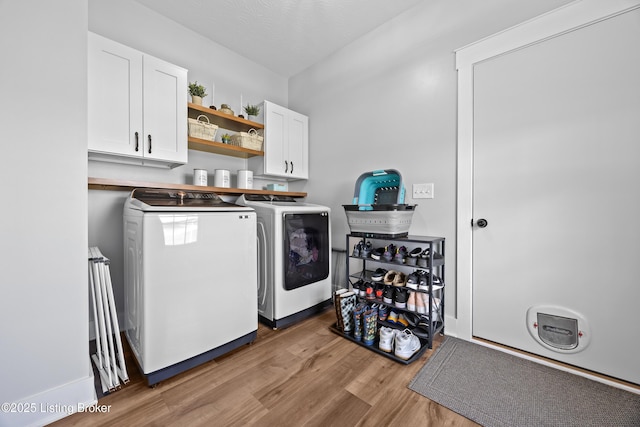 37 Lazy J Ln, Brandenburg, KY 40108 - laundry area featuring washer and clothes dryer, cabinet space, and wood finished floors