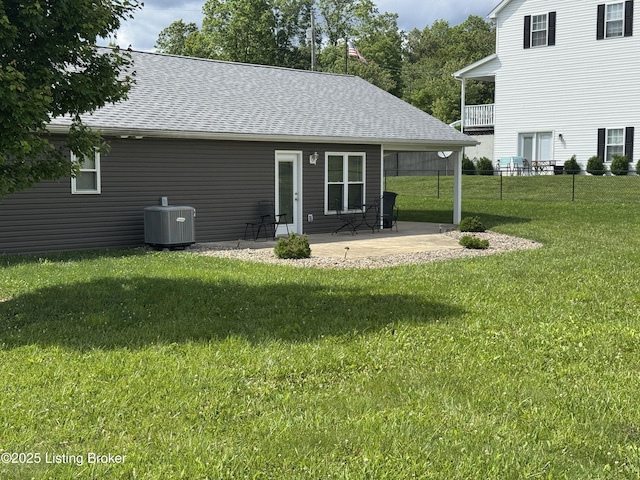 106 Hunter Ln, Brandenburg, KY 40108 - back of property with central air condition unit, a patio, a shingled roof, and a balcony