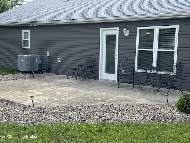 106 Hunter Ln, Brandenburg, KY 40108 - back of property featuring a patio, central AC unit, and roof with shingles