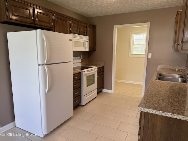 106 Hunter Ln, Brandenburg, KY 40108 - kitchen featuring white appliances, a sink, dark brown cabinetry, light tile patterned flooring, and a textured ceiling
