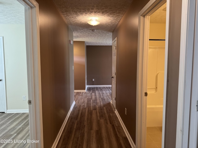 106 Hunter Ln, Brandenburg, KY 40108 - hall with a textured ceiling, baseboards, and dark wood-type flooring