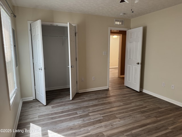 106 Hunter Ln, Brandenburg, KY 40108 - unfurnished bedroom featuring wood finished floors, a closet, baseboards, and a textured ceiling
