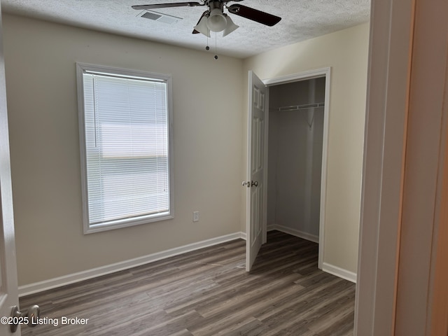 106 Hunter Ln, Brandenburg, KY 40108 - unfurnished bedroom with wood finished floors, a textured ceiling, baseboards, a closet, and a ceiling fan