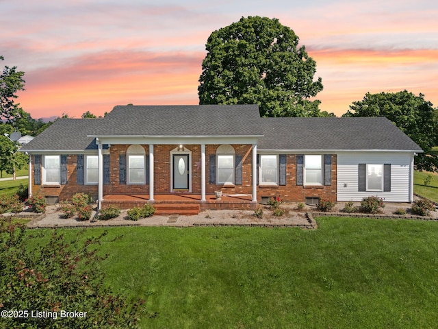 13429 Anneta Rd, Leitchfield, KY 42754 - view of front of home featuring brick siding, covered porch, a front lawn, and a shingled roof