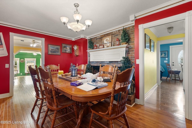 13429 Anneta Rd, Leitchfield, KY 42754 - dining room with ornamental molding, wood-type flooring, baseboards, a ceiling fan, and a chandelier