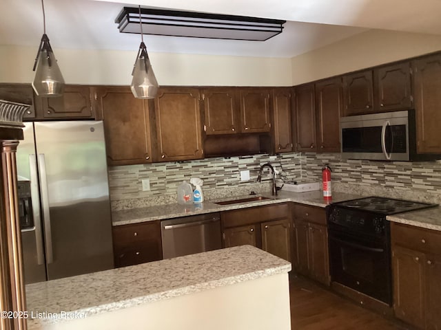 1815 Gardiner Ln Unit A9, Louisville, KY 40205 - kitchen with appliances with stainless steel finishes, a sink, decorative backsplash, hanging light fixtures, and dark wood-type flooring