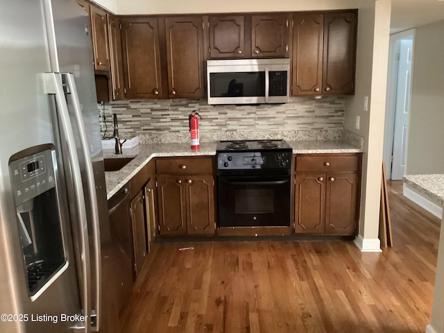 1815 Gardiner Ln Unit A9, Louisville, KY 40205 - kitchen featuring stainless steel appliances, wood finished floors, backsplash, and dark brown cabinets