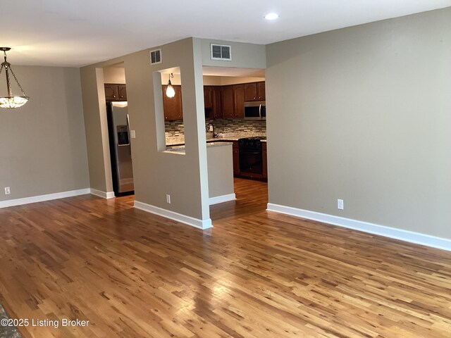 1815 Gardiner Ln Unit A9, Louisville, KY 40205 - unfurnished living room featuring a chandelier, wood finished floors, and recessed lighting