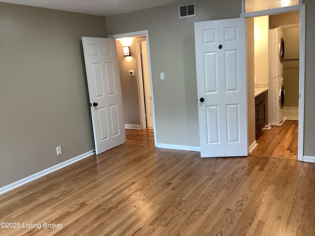 1815 Gardiner Ln Unit A9, Louisville, KY 40205 - unfurnished bedroom with estacked washer and dryer and light wood-style floors