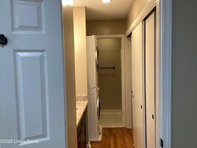 1815 Gardiner Ln Unit A9, Louisville, KY 40205 - bathroom with stacked washing machine and dryer, wood finished floors, and vanity