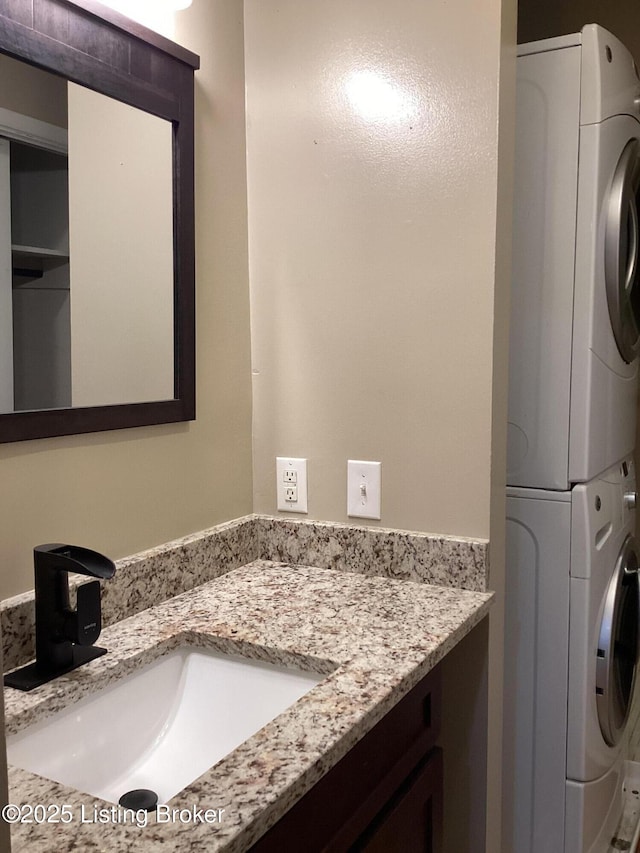 1815 Gardiner Ln Unit A9, Louisville, KY 40205 - bathroom with stacked washer / drying machine and vanity