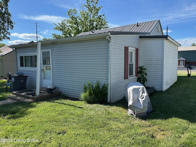 1629 Bardstown Rd, Hodgenville, KY 42748 - view of side of home with a lawn, metal roof, and entry steps