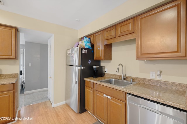 7917 Edsel Ln, Louisville, KY 40291 - kitchen featuring stainless steel appliances, a sink, light wood finished floors, baseboards, and brown cabinets