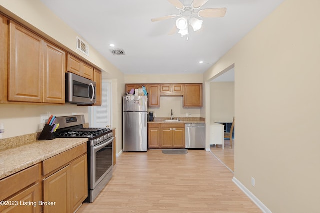7917 Edsel Ln, Louisville, KY 40291 - kitchen with stainless steel appliances, a sink, light wood-style floors, light countertops, and recessed lighting