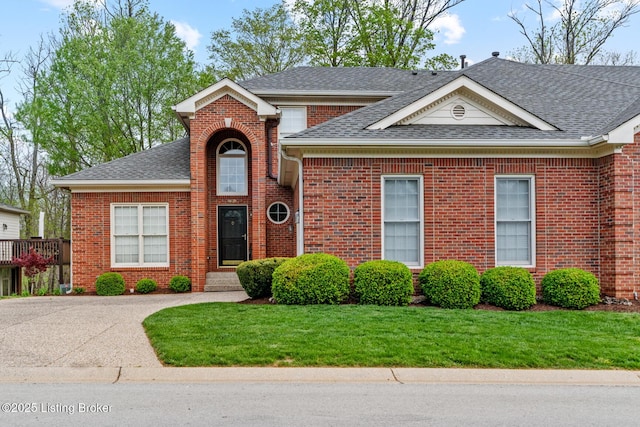 10121 Cave Creek Rd, Louisville, KY 40223 - view of front facade with a shingled roof, brick siding, and a front yard