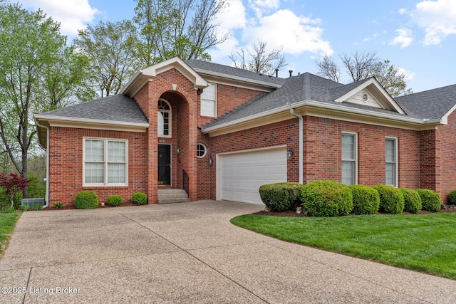 10121 Cave Creek Rd, Louisville, KY 40223 - traditional home with a shingled roof, driveway, brick siding, a garage, and a front lawn